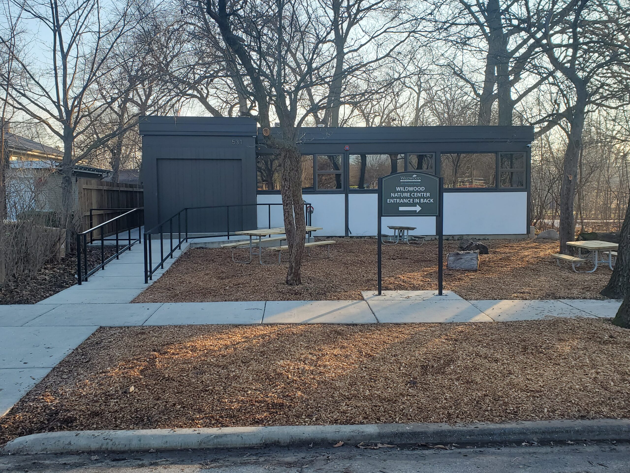 front view of the Wildwood Nature Center that includes the poured concrete walkway and ramp to the front entrance